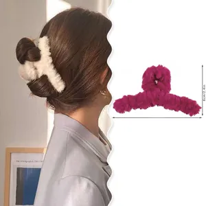 Detail view of plush shark hair claw with size measurements and model wearing demo