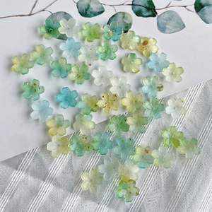 Detail shot of gradient blue and green resin flower beads with golden speckles for DIY