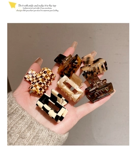 Selection of mini acetate hair claws featuring leopard print and checkerboard patterns