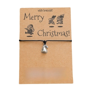 Handmade woven Christmas hat charm bracelet with a Merry Christmas wish card on white background