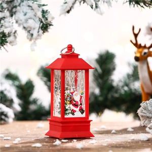 Macro view of red Christmas LED lantern ornament with Santa Claus and metal hanging ring