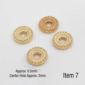 Close-up of golden vintage textured metal spacer beads with 6.5mm outer diameter and hole