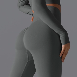 Detailed view of dark grey scrunch butt leggings and long sleeve seamless yoga set