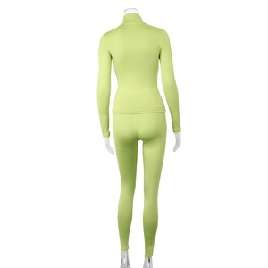 Rear view of grass green two-piece athletic yoga set with stand collar and slim fit pants