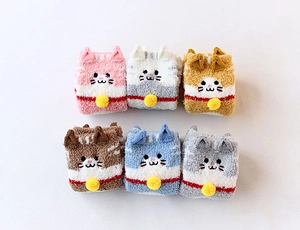 Folded fuzzy coral fleece socks with cute cat ears and pom-pom collar detail