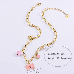Detail of gold chain necklace with pink flower, butterfly charms and white pearl pendant