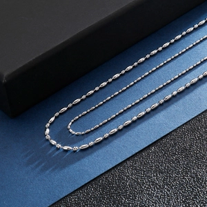 Collier chaîne à billes en acier inoxydable poli pour hommes sur fond bleu et noir mat
