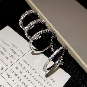 Set of four silver star charm rings with cubic zirconia pavé and fine metal chains