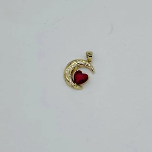 Detailed view of gold crescent moon pendant with red heart gemstone and zircon inlay