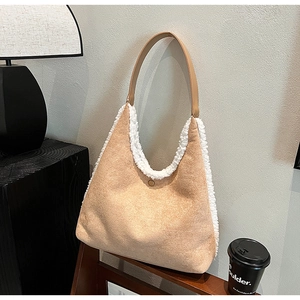 Detail of contrast suede tote bag with white faux shearling trim and brown leather strap