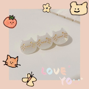 Detailed view of three cute pearlescent acetate cat hair clips on a pink background