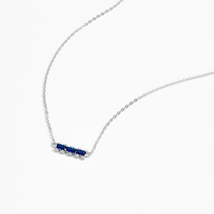 Detailed macro shot of 925 silver necklace with three rectangular blue gemstones