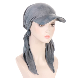 Detail of grey tie-dye headscarf cap with brim and adjustable side straps on a model