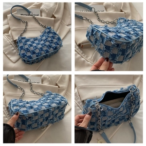 Detail view of denim checkerboard bag showing silver chain, fringes and interior layout