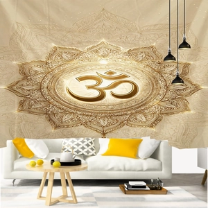 Detail of gold Mandala Om tapestry hanging as a background in a modern living room