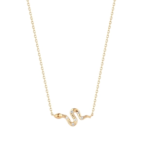 Macro shot of gold snake pendant with five sparkling stones and fine chain detail