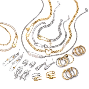 Luxury gold and silver jewelry set with paperclip chain, heart charms, and pearls