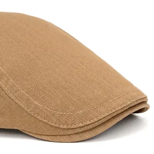 Unisex khaki cotton flat cap with wide brim and precision stitching on white background