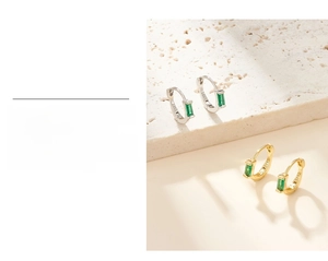 Macro shot of S925 sterling silver earring featuring an emerald green zircon gemstone