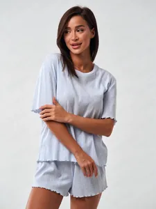 Detail of light blue pajama set showing ribbed texture and ruffled edges on sleeve