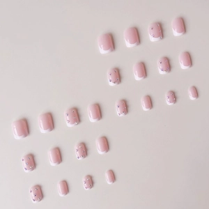 French ballet style press-on nails in pink and white with sparkling rhinestones