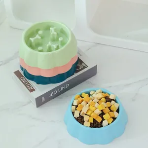 Slow feeder dog bowl set with bone-shaped obstacles in pastel blue and pink colors