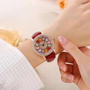 Elegant ladies watch with rose gold dial and red leather strap on a model's wrist