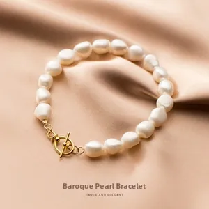 Baroque pearl bracelet featuring irregular white pearls and elegant golden OT clasp closure