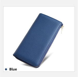 Macro shot of long blue leather wallet showing litchi grain texture and gold zipper