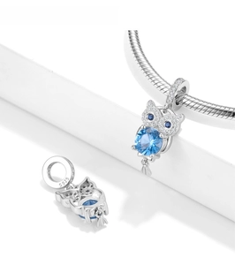 Detailed close-up of 925 sterling silver owl charm with faceted blue gemstone and zircons