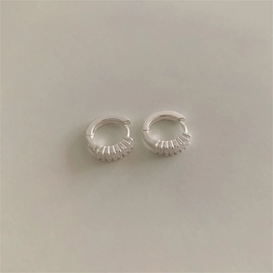 Detailed view of 925 sterling silver hoop earrings with pavé cubic zirconia accents