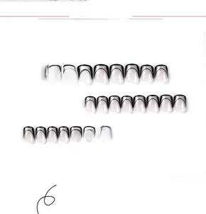 Detail view of 24pcs glossy short French press-on nails with black tip and creamy base