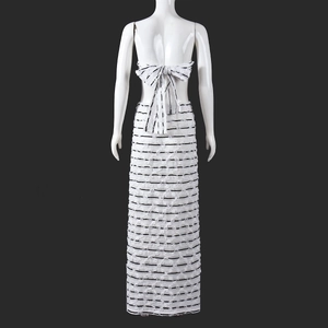 Detail of white striped crop top with large back bow tie and matching maxi skirt