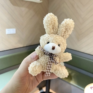 Cute beige plush rabbit with bow tie, soft lamb wool texture mascot for backpacks