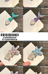 Detail of mermaid tail and heart hair clips with pearlescent finish and gradient colors