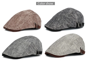 Detail view of four men's flat caps in tweed and corduroy with metal buckle accents