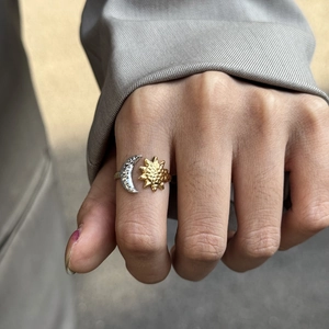 Detail of 18K gold sun and silver moon adjustable ring with hammered texture
