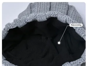 Detailed macro view of the thick black fleece lining inside the grey winter knitted beanie
