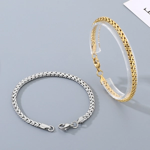 Detail view of woven gold and silver dragon bone chains with secure lobster clasps