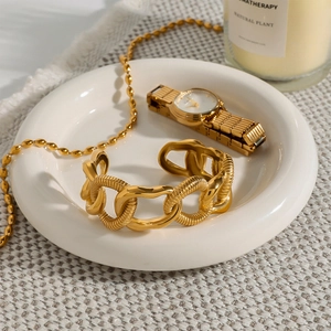 Elegant gold stainless steel chunky chain bracelet displayed on a white tray