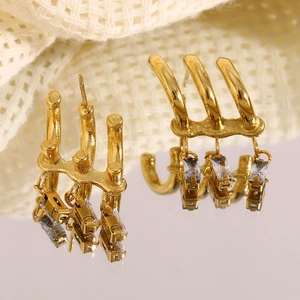 Macro shot of 18K gold plated tiered earrings with dangling rectangular zircon stones