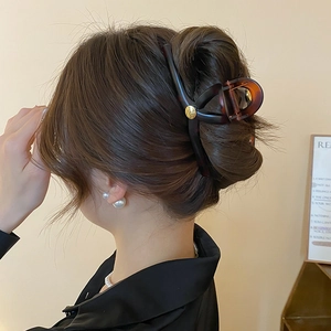 Elegant tortoiseshell hair claw clip for women featuring gold COCO logo detail