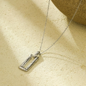 Silver rectangle pendant necklace with hammered texture in minimalist geometric style