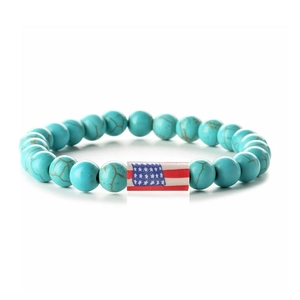 Detail of turquoise beads bracelet with American flag charm on white background