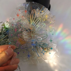 Rainbow suncatcher window film with leaf and moon patterns creating vibrant light shadows