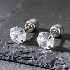 Macro detail of 6mm round zircon stud earrings with silver-tone four-prong setting