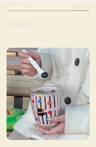 Close-up of portable double-layer fruit cup with pink drain basket and fork spoon
