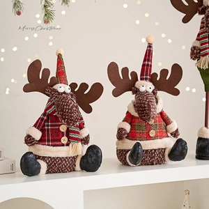 Cute plush Christmas reindeer figures with red plaid hats and faux fur on a white shelf