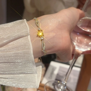 Close-up of elegant gold branch bracelet with zircon stars worn on a woman wrist
