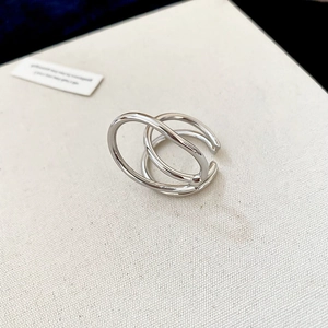 Macro shot of silver multi-layered geometric ring with minimalist polished surface